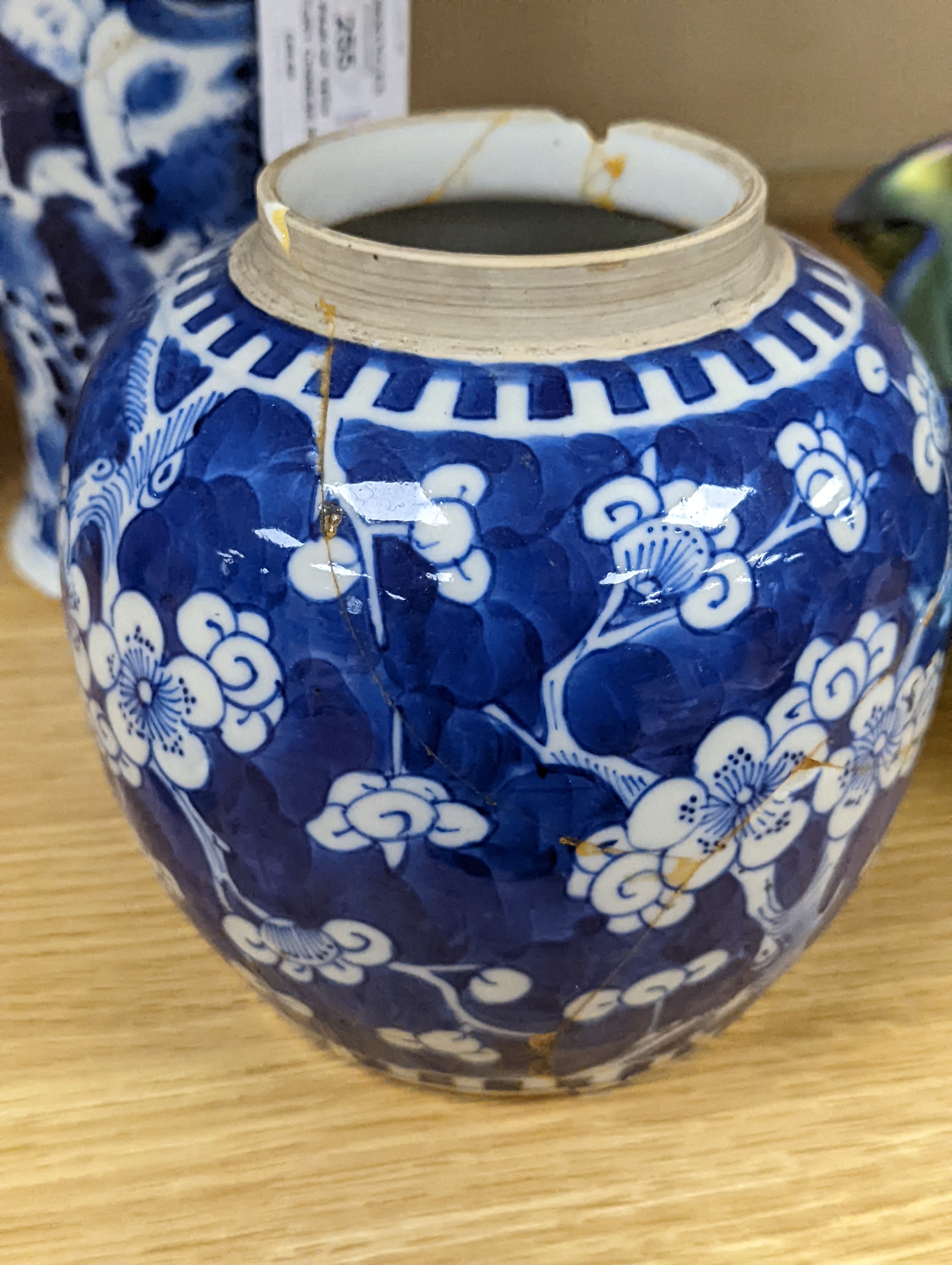 A pair of 19th century Chinese blue and white vases, a prunus vase and cover and a similar jar (4), pair of vases 24 cms high.